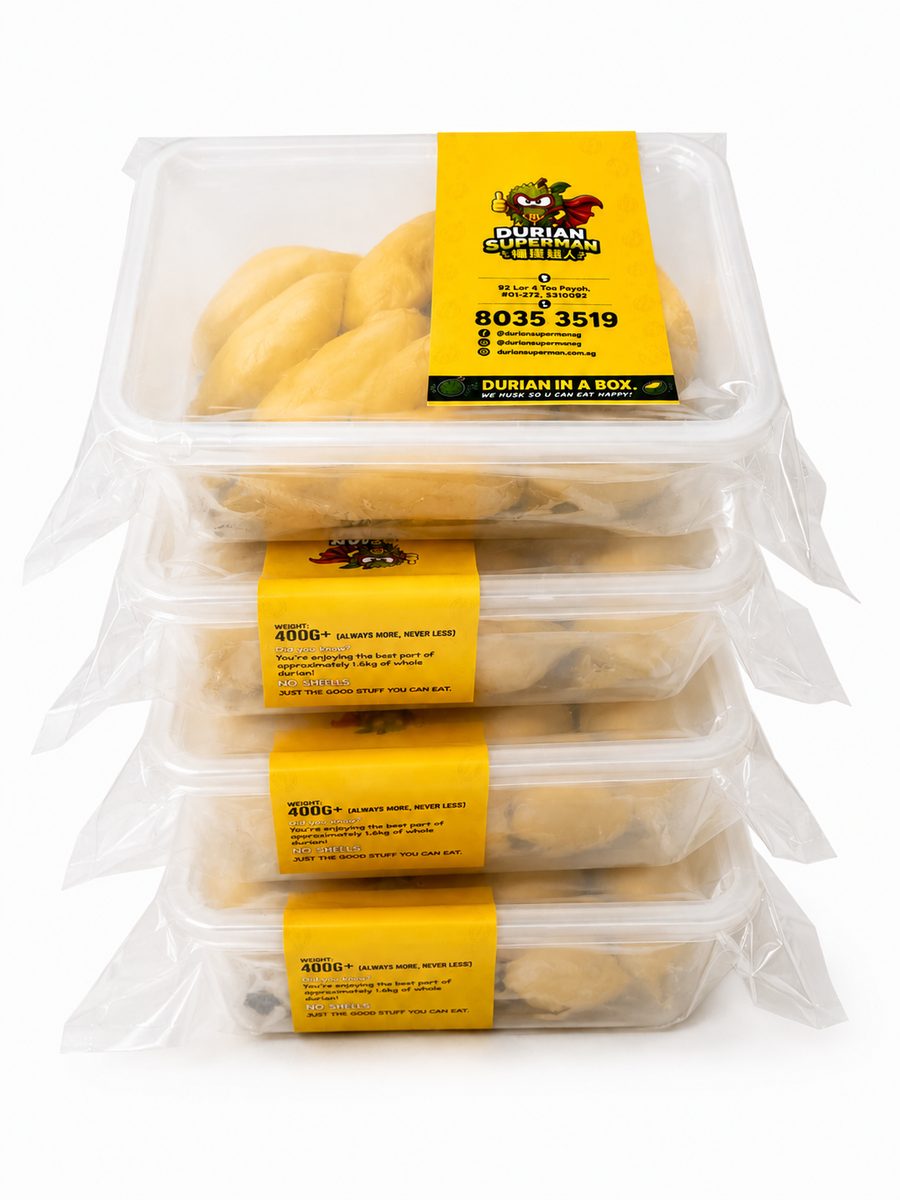 A stack of Durian Superman boxes — dehusked durian flesh vacuum sealed under the yellow label